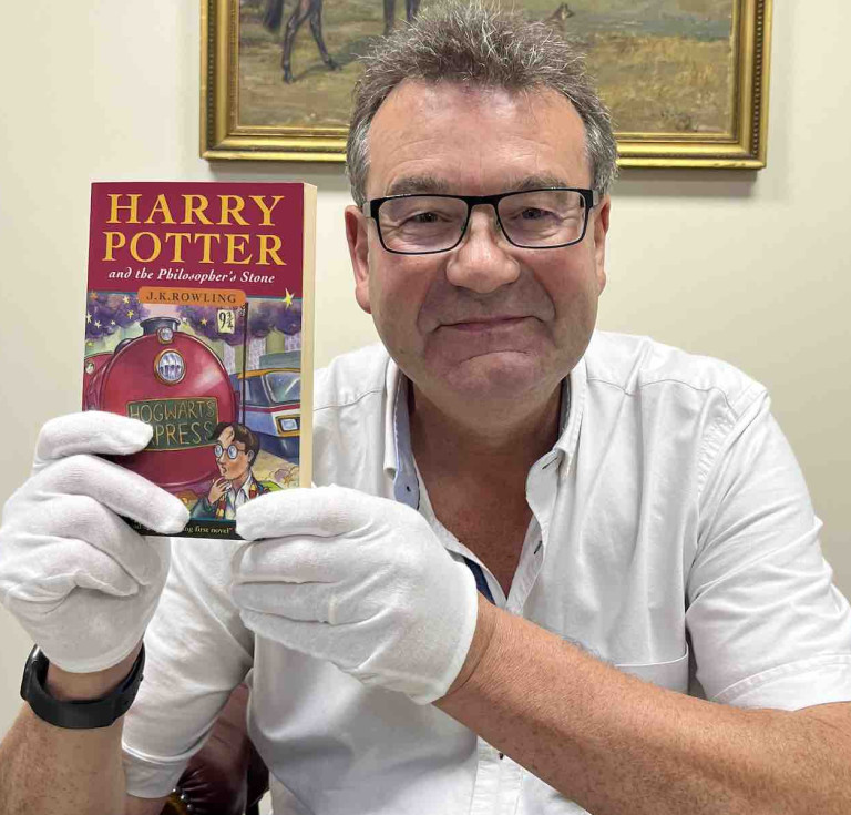 Auctioneer Richard Winterton with the Harry Potter book